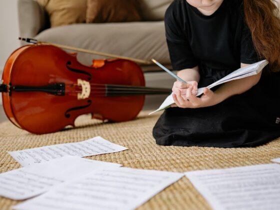 A child studying for their music classes near me