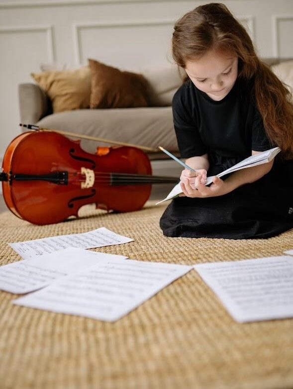 A child studying for their music classes near me